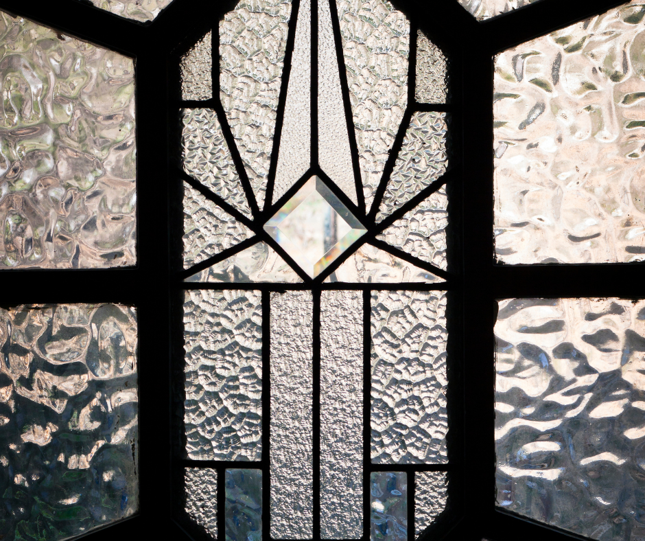 Refresh your older house showing decorative, beveled glass front door with black borders and trim around the glass.